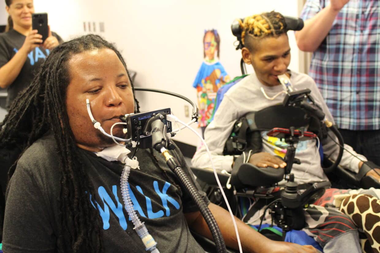 Two black men using Quadsticks.