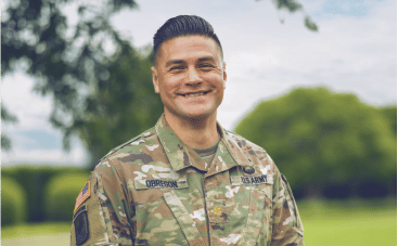 A young man wearing a military camo uniform