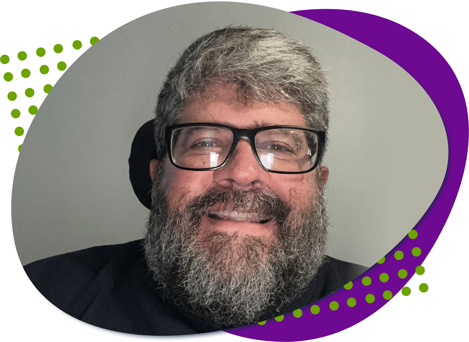 A photo of Chris. He has a beard and wears black glasses.