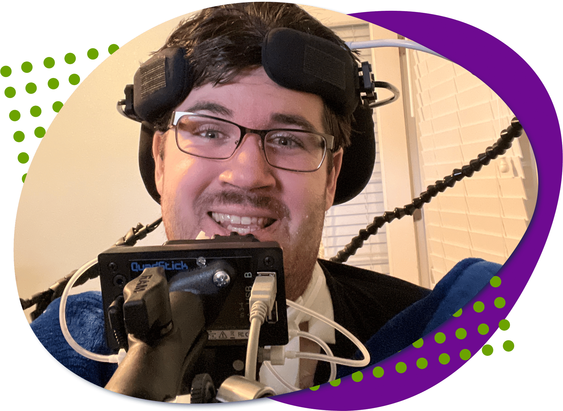 Dylan W large stack Dylan W a dark haired guy with glasses. His quadstick, a controller you use your mouth, is in front of him.