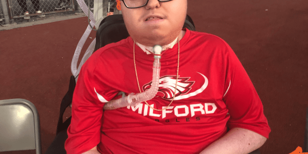 A photo of Glenn, he is wearing a red Milford Eagles shirt