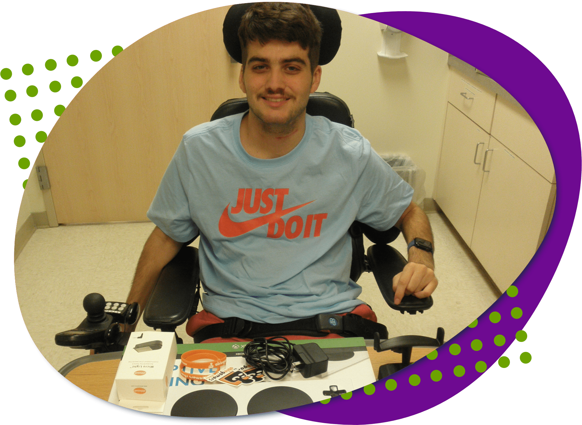 A photo of Grant. He has dark brown hair and a mustache he iw wearing a blue nike tshirt with the slogan Just Do It