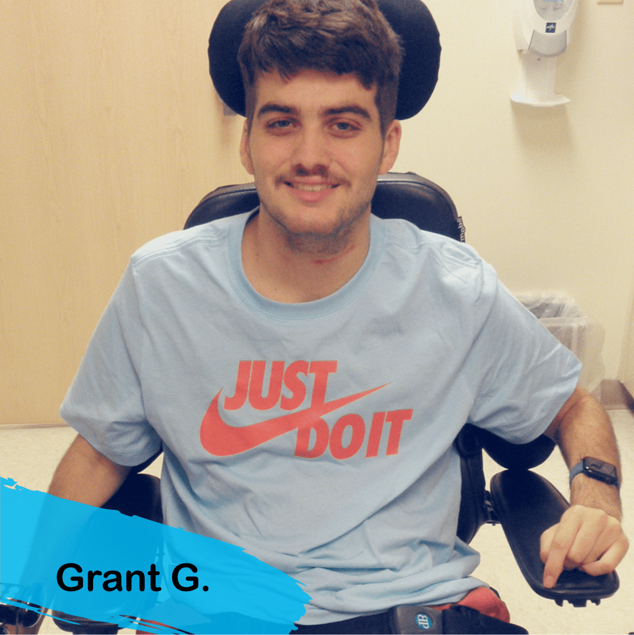 A photo of Grant. He has dark brown hair and a mustache he iw wearing a blue nike tshirt with the slogan Just Do It