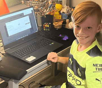Hudson An image of a child smiling using a laptop to game