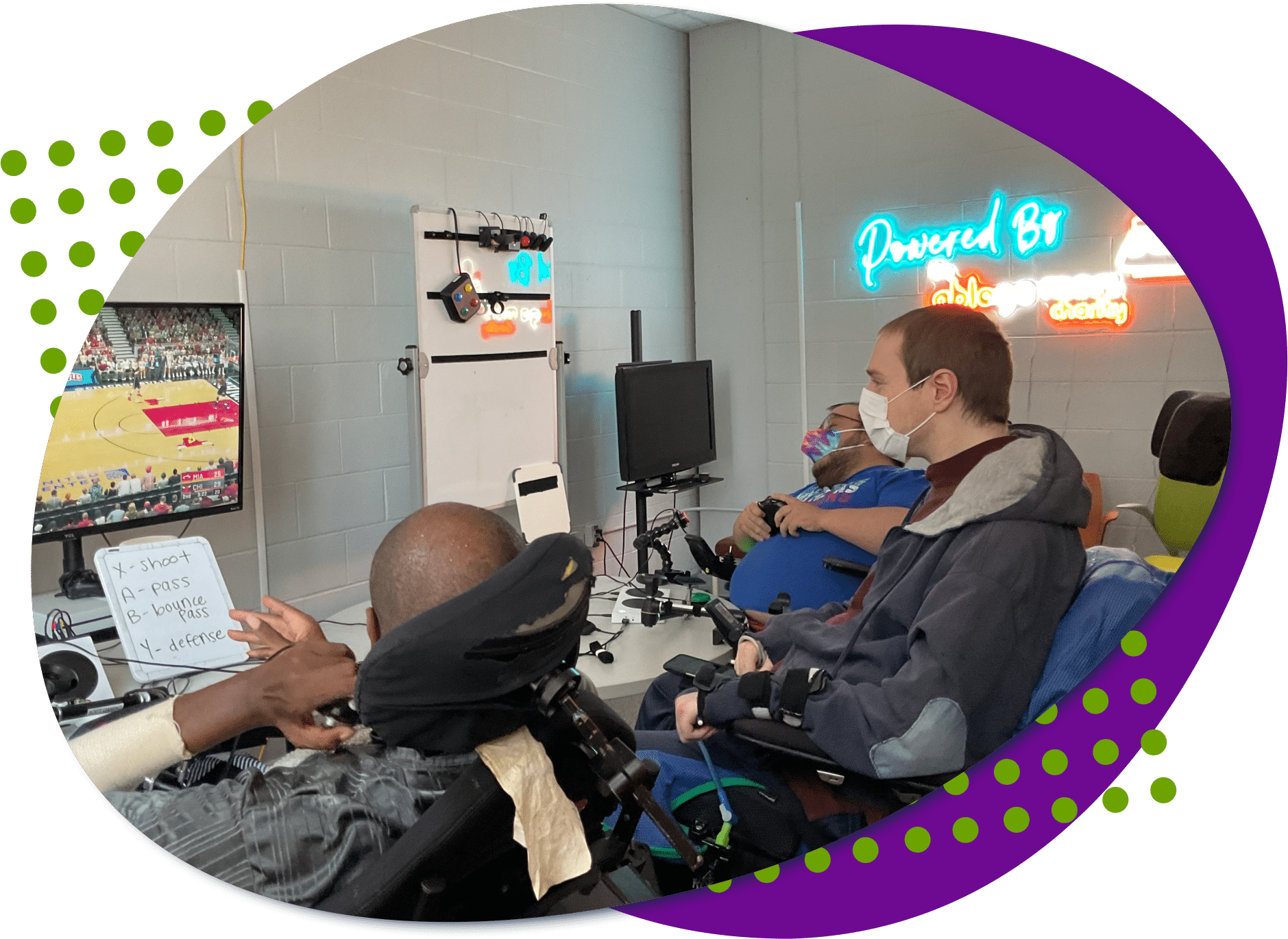 Three individuals playing a video game together at Powered by AbleGamers partner Ability KC- Why Inclusive Gaming Matters