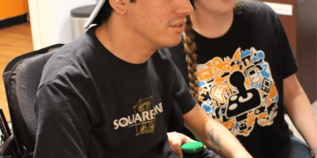 peer counselor helping a young man find the right adaptive controller