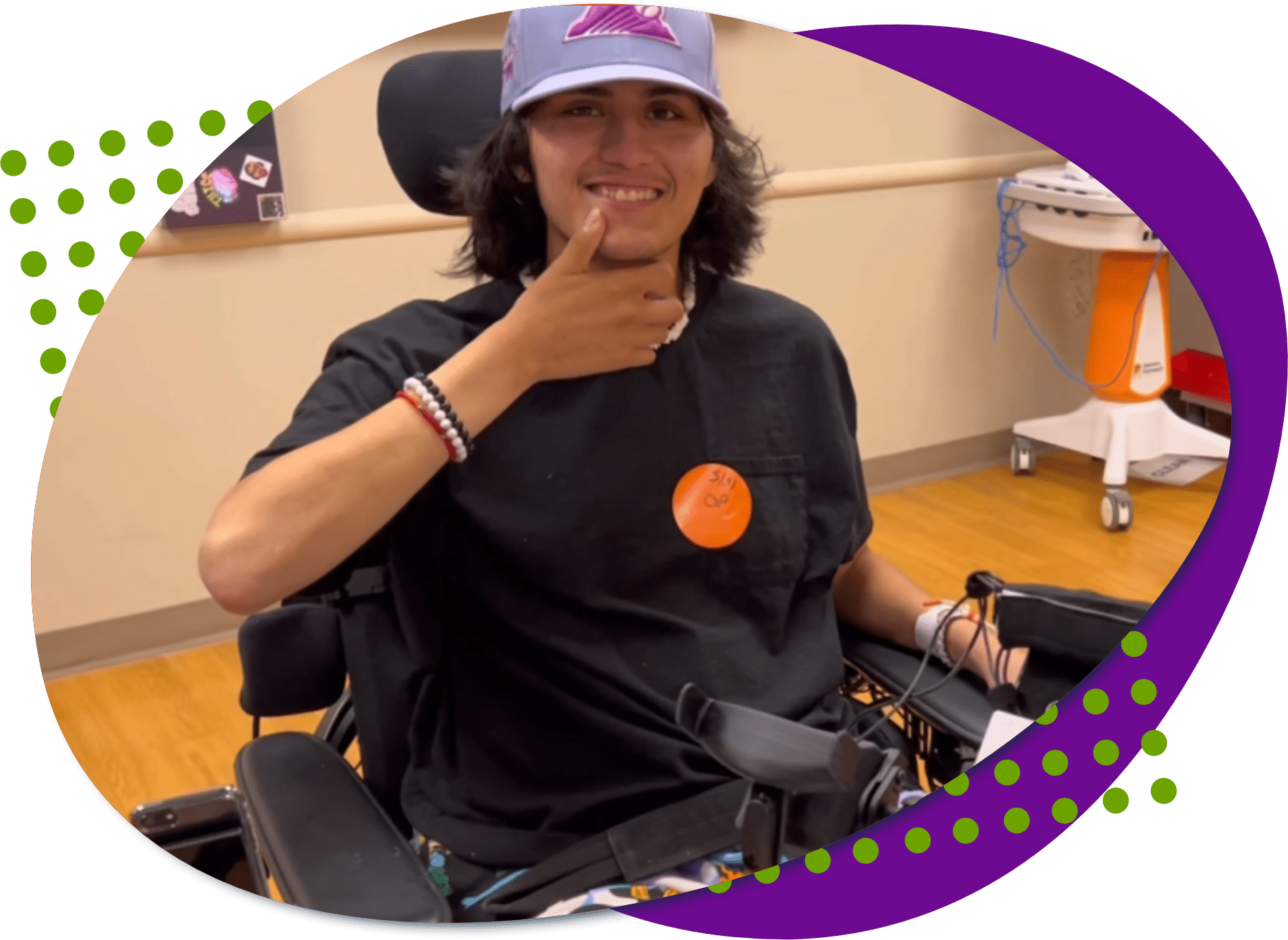 A photo of Jon, he has black hair and brown eyes, he is wearing a baseball cap and a black t-shirt. He is smiling and giving the thumbs up.