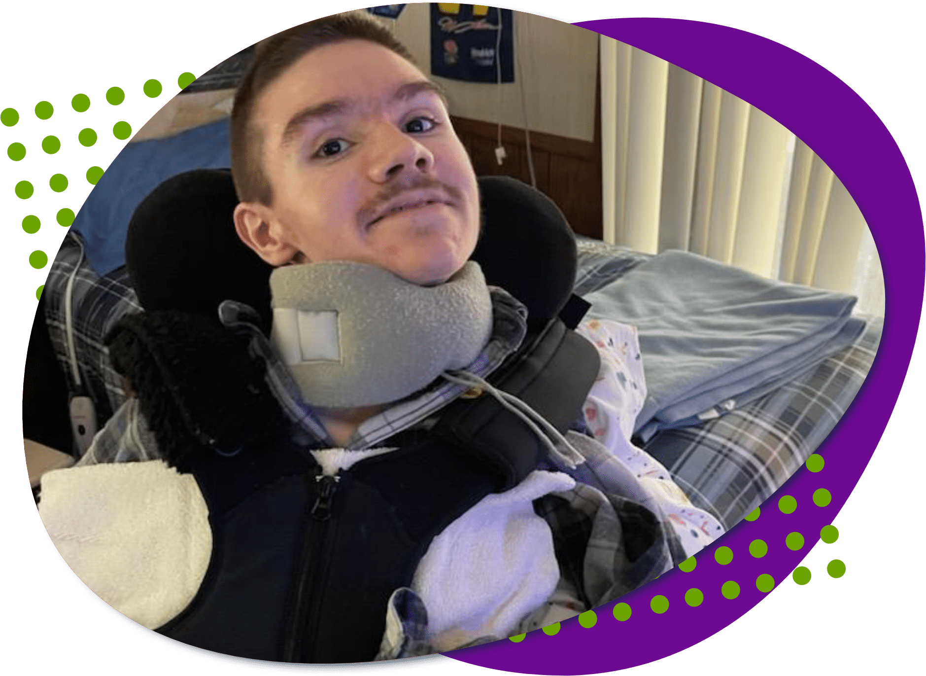 A photo of Jonathan, he has short dark brown hair and brown eyes, he is wearing a grey plaid shirt and he is smiling.