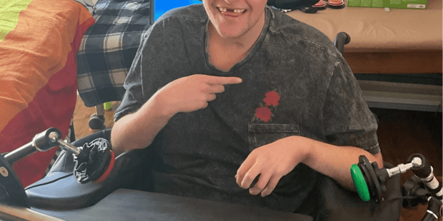 A photo of Oliver with some of his adaptive gaming equipment. gaming is a life-enriching activity