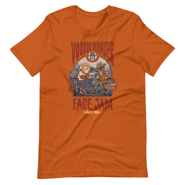 Orange Shirt that says "Voodoo Ranger Face Jam" A monkey mascot and a scekelton mascot from the brands are enjoying an outdoor meal.
